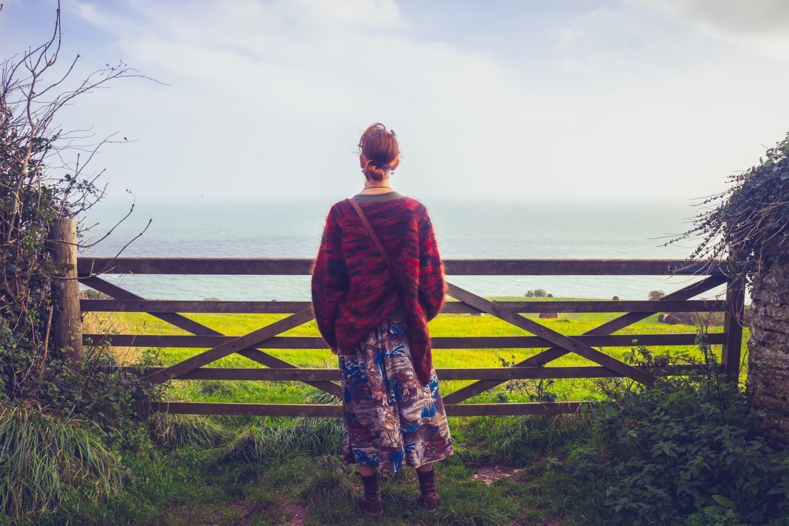 young woman looking at natural burial site