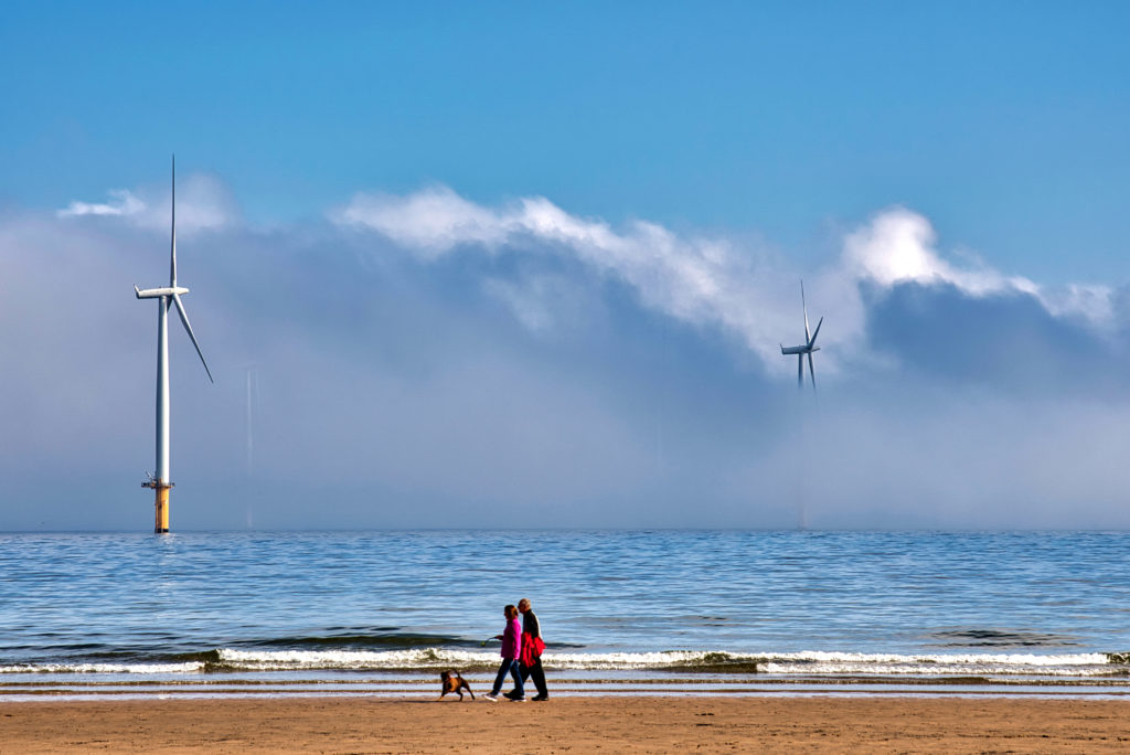 grieving couple stroll on beach